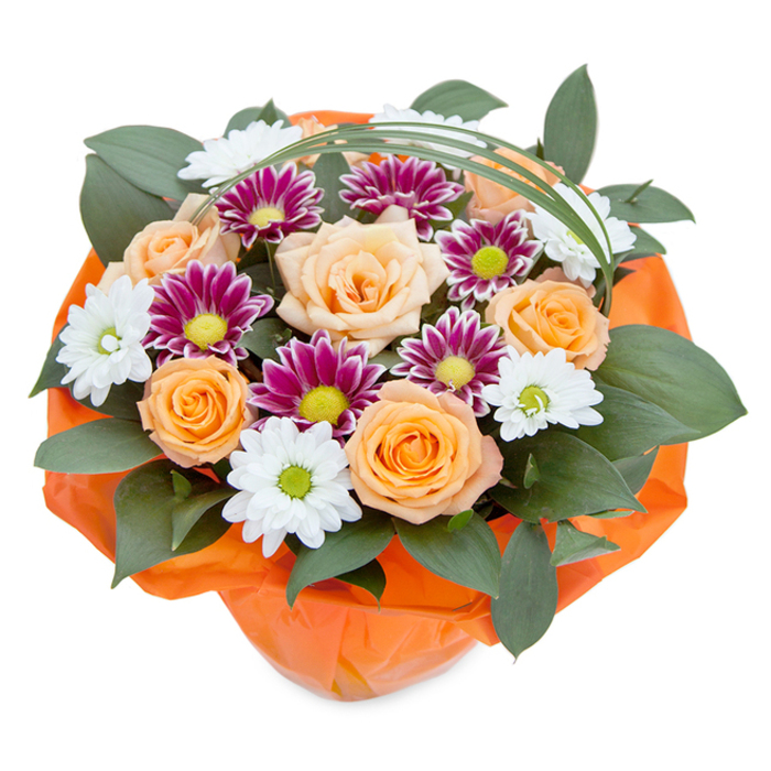 A vivid top-down portrait reveals this lush bouquet set against a brilliant white background, celebrating the artistry and heart behind every Sutton floral gift. Dominating the centre, roses transition from whispering peach to rich golden orange, their layered petals opening like little lanterns of hope and happiness. Nestled between them, chrysanthemums in snowy white and bold magenta show off myriad fine petals, each one a study in texture and depth. The white varieties-daisy-like with luminous green centers-evoke the simple joy of daisies glimpsed on the Green at Carshalton, while vibrant magenta types radiate contrast and energy, reminiscent of early summer evenings in Sutton's bustling town squares. Abundant, glossy green leaves-perhaps ruscus or eucalyptus-anchor and fill out the arrangement, peeking between the blooms to add balance, shadow, and dimension. Overarching everything is a slender strand of bear grass, tracing a gentle curve that lends light movement and a touch of whimsy to the bouquet's outline. At the base, vibrant orange wrap in a crinkled finish envelopes the stems, echoing the warmth of Sutton's welcome and enhancing the bouquet's festive spirit. Perfect for marking birthdays, anniversaries, or simply sending a bit of local cheer, this bouquet brims with thoughtful craft and emotion rooted deeply in Sutton tradition.
